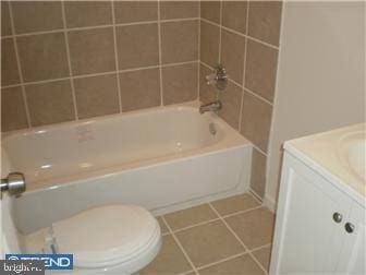 full bathroom with vanity, toilet, tile patterned flooring, and shower / bathing tub combination