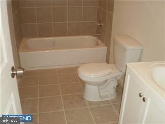 bathroom with tile patterned flooring, vanity, and toilet