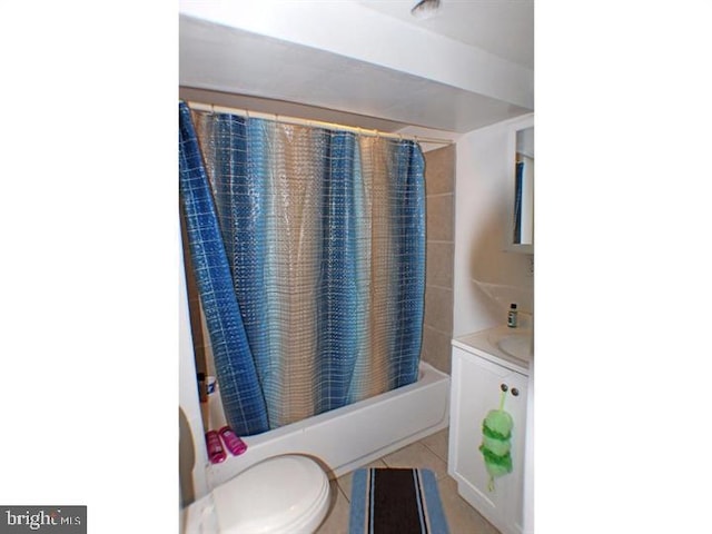 bathroom featuring toilet, tile patterned flooring, and shower / bath combo with shower curtain