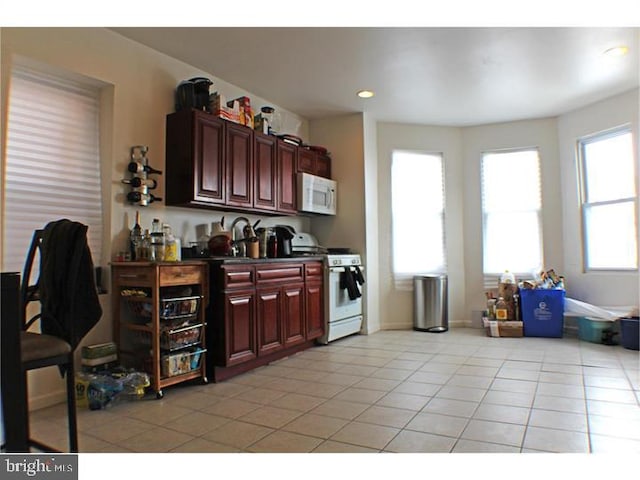 kitchen featuring white appliances and light tile patterned floors