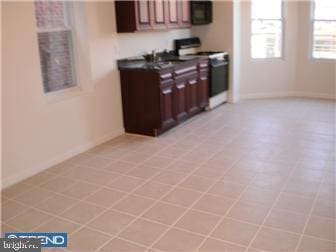 kitchen with white electric stove and sink