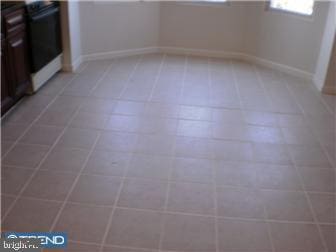 spare room with tile patterned floors