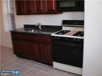 kitchen featuring stove and sink