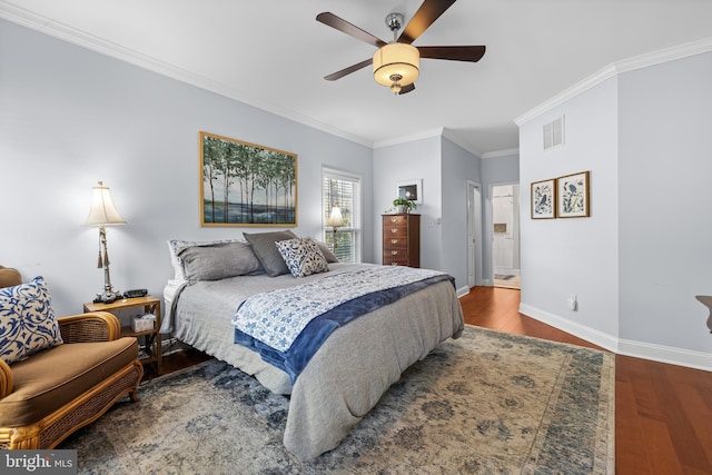 bedroom with ceiling fan, wood finished floors, visible vents, baseboards, and crown molding