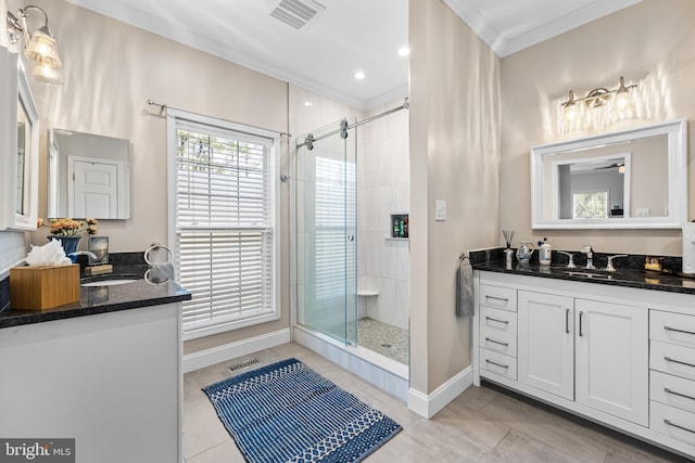 bathroom featuring a stall shower, visible vents, crown molding, and baseboards