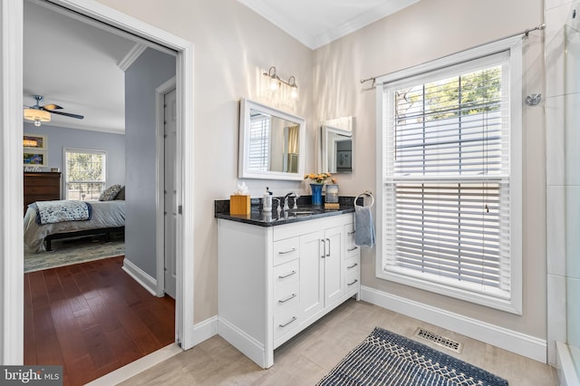 ensuite bathroom featuring a ceiling fan, visible vents, crown molding, and wood finished floors