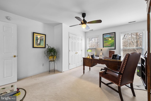 office area with baseboards, visible vents, ceiling fan, and carpet flooring