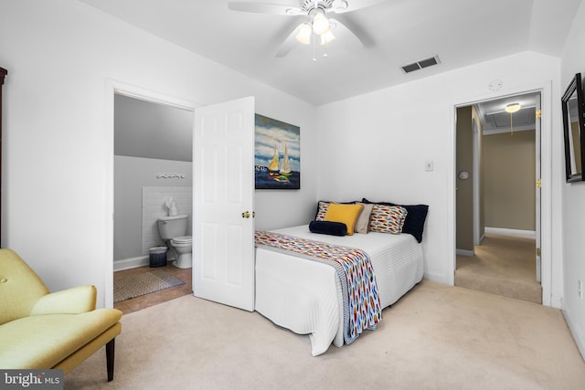 bedroom with attic access, visible vents, connected bathroom, light colored carpet, and lofted ceiling