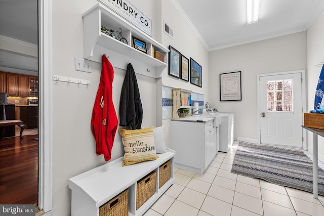 mudroom featuring light tile patterned floors, independent washer and dryer, visible vents, and crown molding