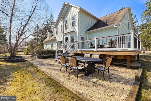 rear view of property featuring a deck