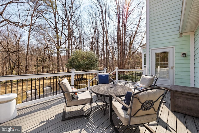 wooden terrace featuring outdoor dining area