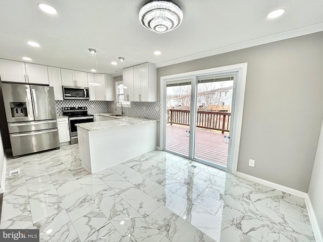 kitchen featuring stainless steel appliances, white cabinetry, decorative backsplash, and kitchen peninsula