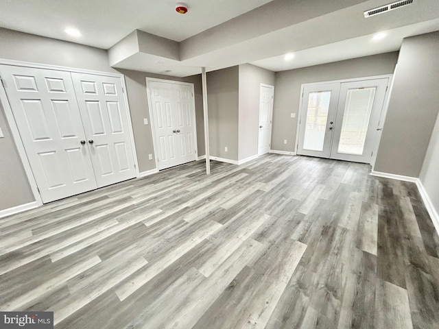 interior space with french doors and light hardwood / wood-style flooring