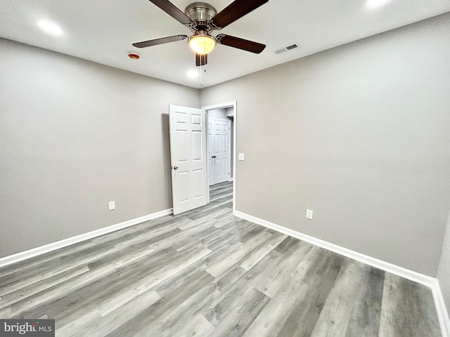 unfurnished room with ceiling fan and light wood-type flooring