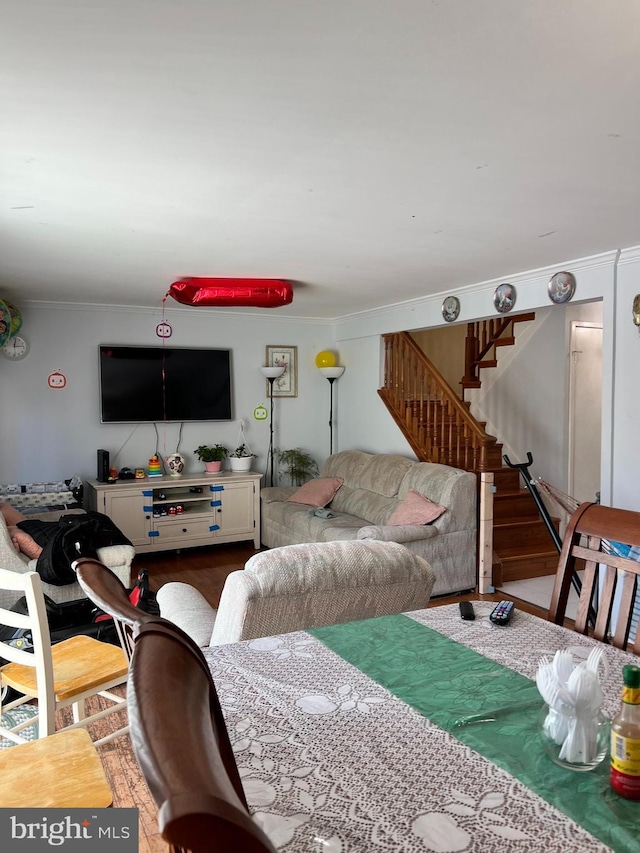 living room with crown molding and wood-type flooring