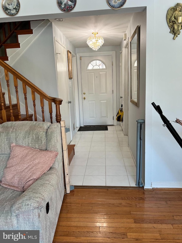 foyer entrance with a chandelier and light hardwood / wood-style flooring