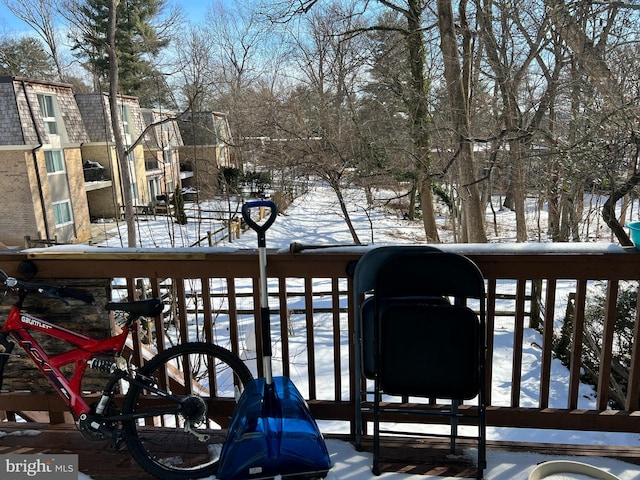 view of snow covered back of property