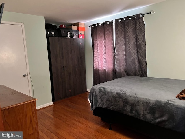 bedroom with wood-type flooring