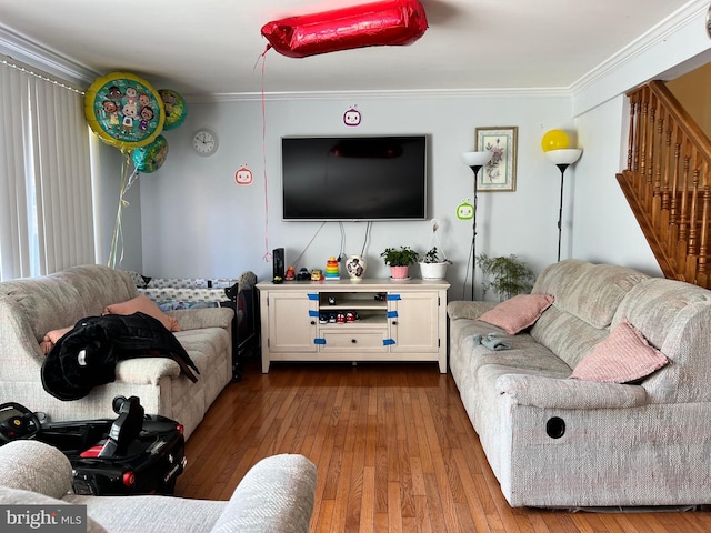 living room with ornamental molding and light hardwood / wood-style floors