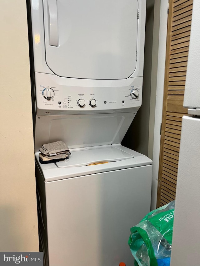 laundry room with stacked washer and dryer