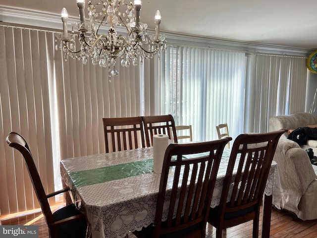 dining room featuring hardwood / wood-style flooring and a chandelier