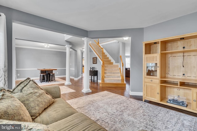 living room with decorative columns and hardwood / wood-style floors