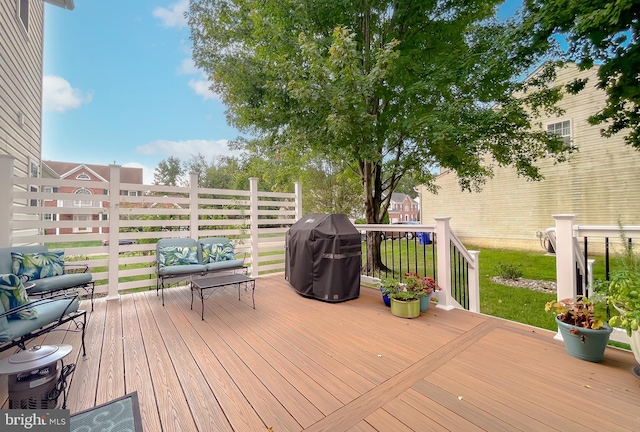 wooden terrace featuring a lawn and grilling area