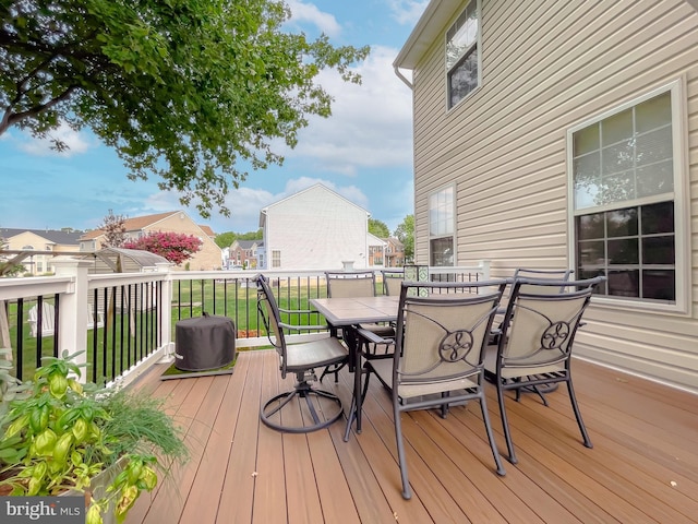 wooden terrace featuring outdoor dining space