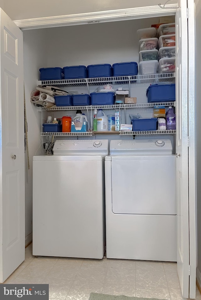 laundry area with light tile patterned floors, laundry area, and washer and dryer