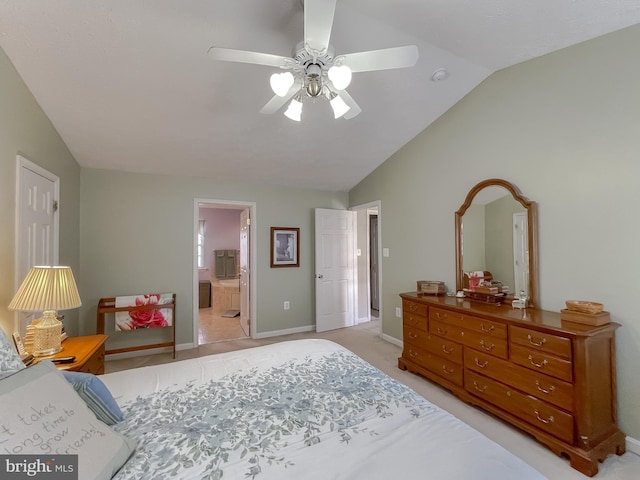 bedroom featuring lofted ceiling, ensuite bathroom, light carpet, a ceiling fan, and baseboards