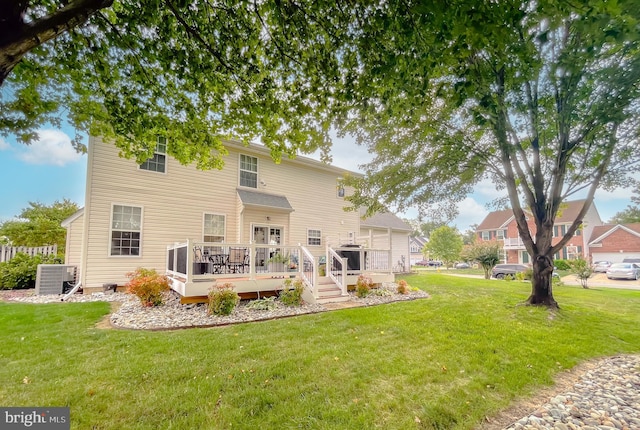 back of property featuring central AC, a lawn, and a wooden deck