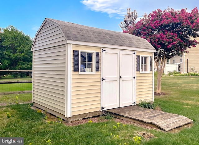 view of shed with fence