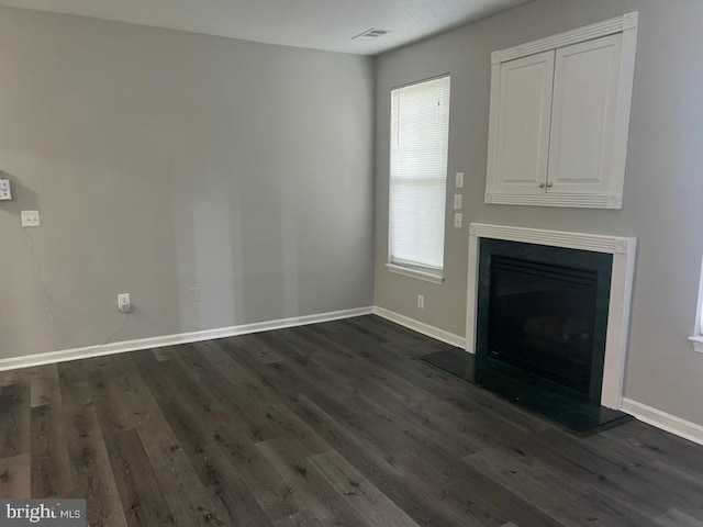 unfurnished living room with dark hardwood / wood-style floors