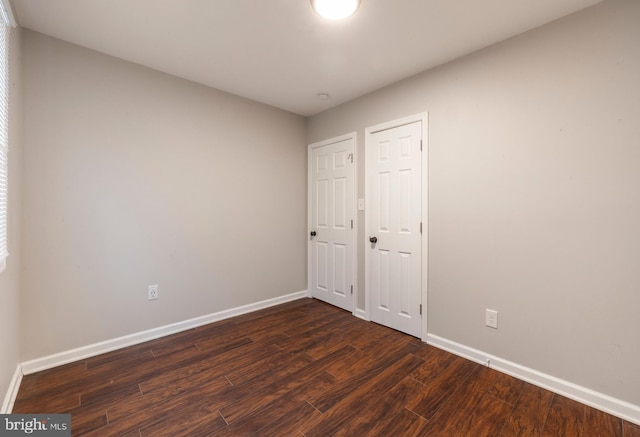 unfurnished bedroom featuring dark hardwood / wood-style floors