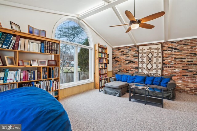 living area with vaulted ceiling with beams, brick wall, carpet floors, and a ceiling fan