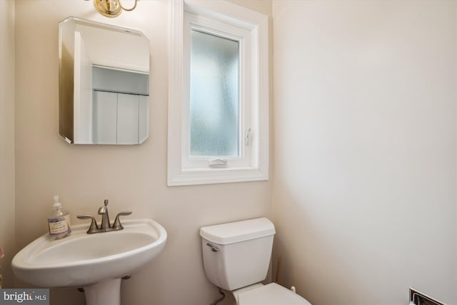 bathroom featuring toilet and a sink