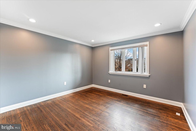 unfurnished room featuring ornamental molding and dark hardwood / wood-style flooring