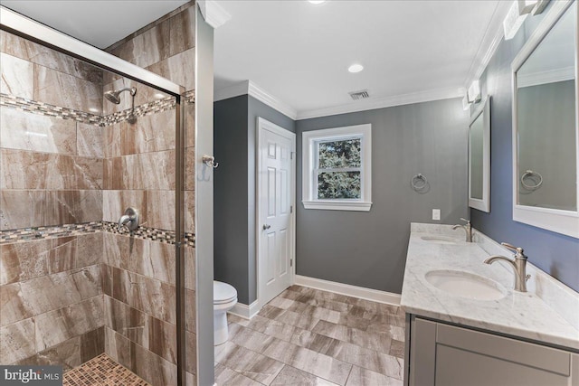 bathroom with vanity, ornamental molding, toilet, and walk in shower