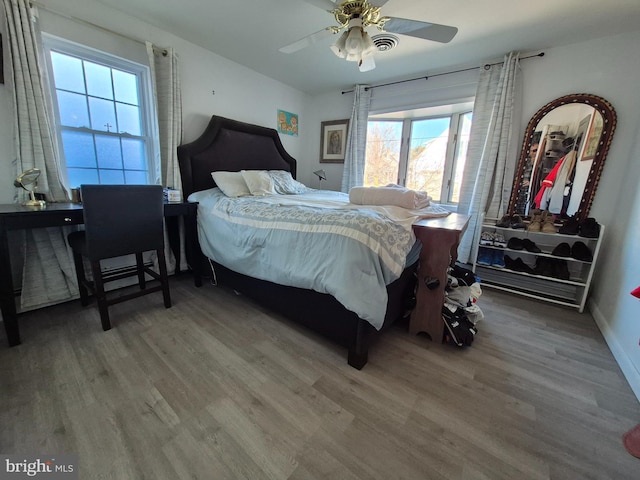 bedroom with hardwood / wood-style floors and ceiling fan