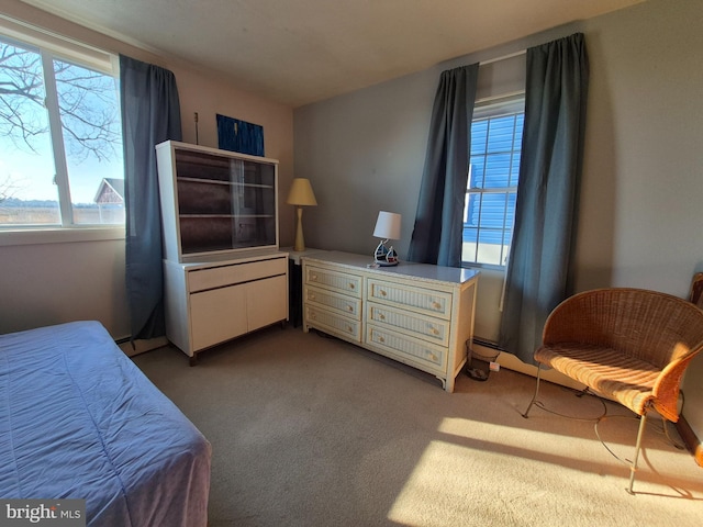 carpeted bedroom with a baseboard heating unit and a water view