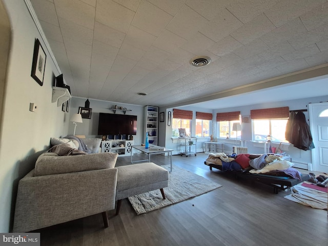 living room with hardwood / wood-style flooring and built in features