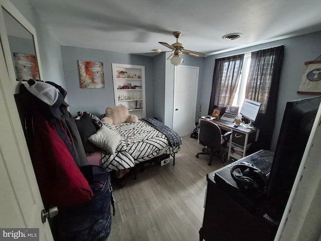 bedroom with light hardwood / wood-style flooring and ceiling fan