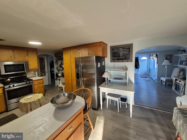 kitchen with dark hardwood / wood-style floors and appliances with stainless steel finishes