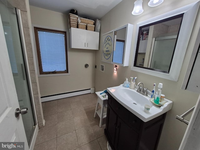 bathroom with a baseboard radiator, vanity, a shower with door, and tile patterned floors