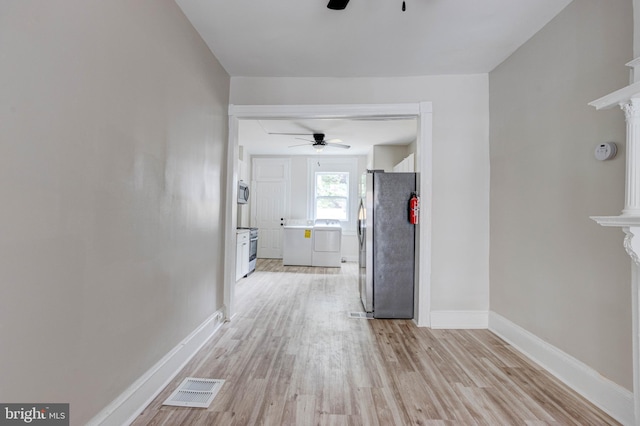 interior space with washer and clothes dryer and light hardwood / wood-style flooring