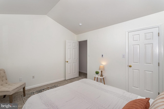 bedroom featuring vaulted ceiling and light carpet