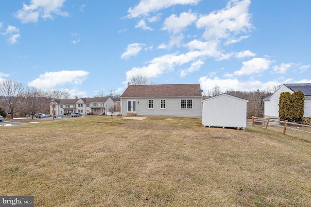 back of house with a lawn