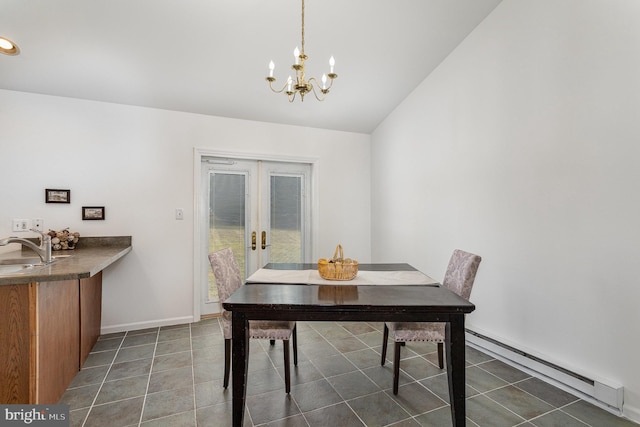 dining room featuring sink, baseboard heating, an inviting chandelier, dark tile patterned flooring, and french doors