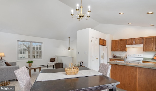 dining room with lofted ceiling, sink, an inviting chandelier, and a baseboard heating unit