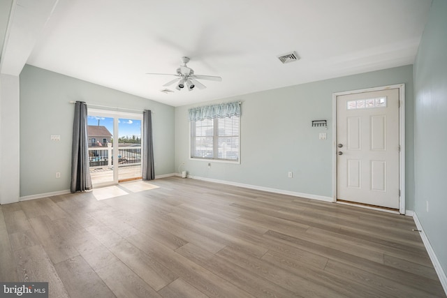 entryway with light hardwood / wood-style flooring, ceiling fan, and vaulted ceiling